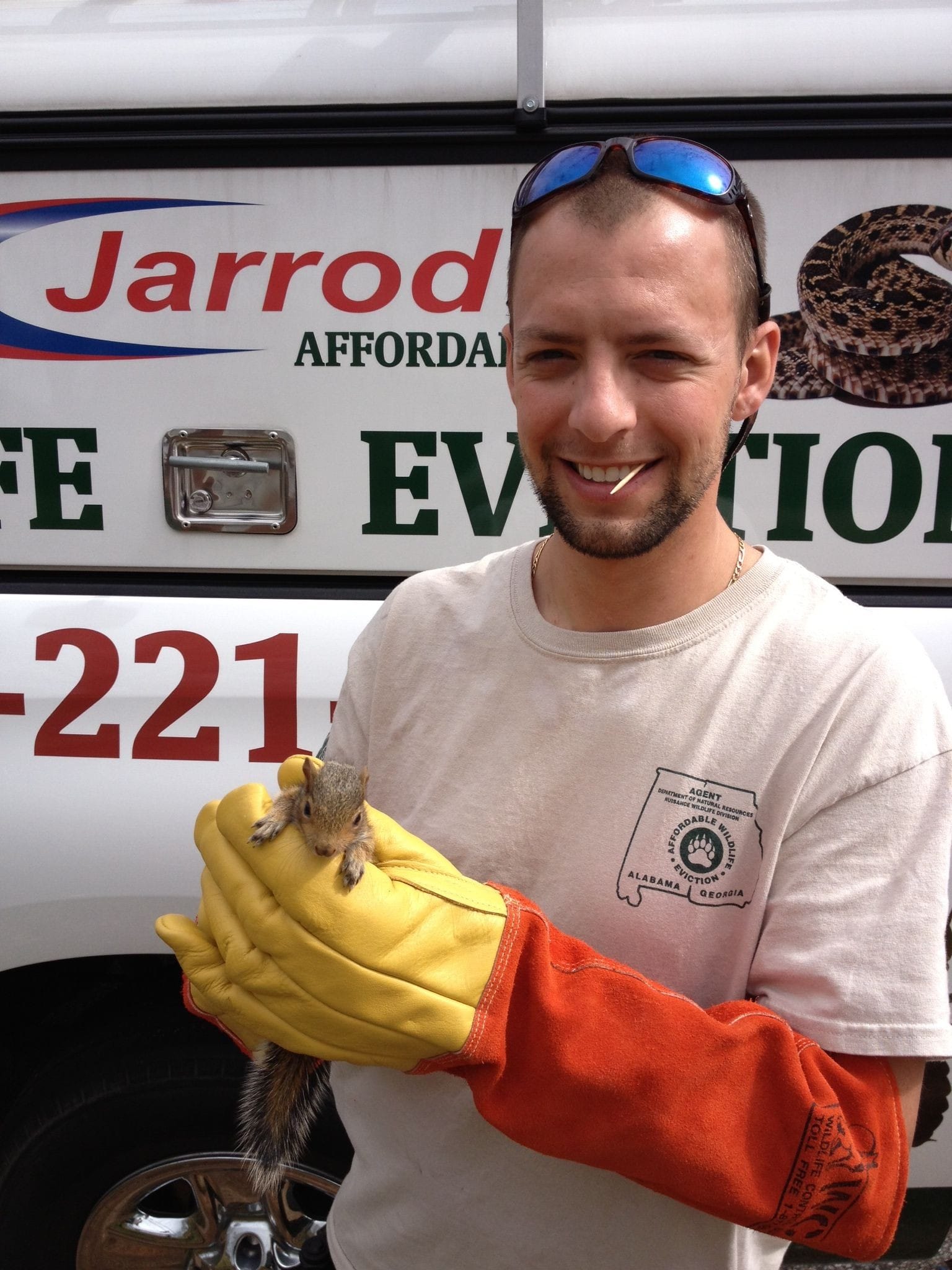 One of our wildlife techs holding a baby squirrel that he captured at a customers home in Columbus, Ga.